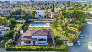 A residential property with a swimming pool, a covered patio, and a view of the surrounding landscape. - Villa Rosanna by Villa Plus (Fontane Bianche)
