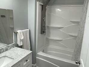 Combined shower/bathtub, hair dryer, towels, soap
