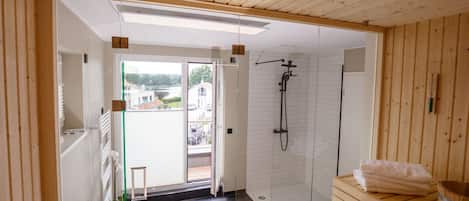 Shower, hair dryer, towels, toilet paper