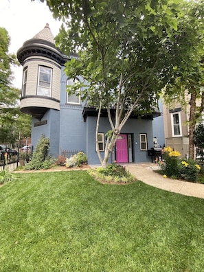 A two-story house with a turret and a pink door. - SPACIOUS GARDEN OASIS IN THE HEART OF DC! WALKABLE TO IT ALL! (Washington)