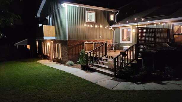 A two-story house with a wooden deck and a staircase leading to the second floor. - ADA King near Crabtree, PNC Arena, State Fairgrounds, NCMA (Raleigh)