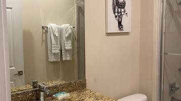 Combined shower/bathtub, hair dryer, towels, soap