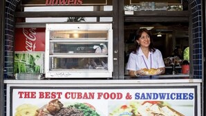 A food truck with a sign advertising 'The Best Cuban Food & Sandwiches'.