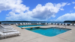 A pool area with lounge chairs and a view of the sea. - Quality Inn - On The Lake Clarksville-Boydton  (Clarksville)