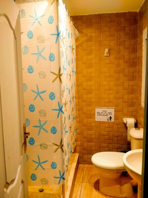 Bathtub, towels, soap, toilet paper