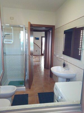 Een douche, een haardroger, een bidet, handdoeken