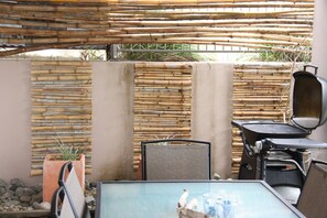 Outdoor dining - Reflections Ground Level 2 Bedroom air-con self-contained apartment, River views (Wooli)