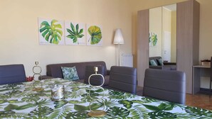 A hotel room with a bed, two armchairs, a sofa, a lamp, and wall art. - 500 mt from Porta Rudiae (Lecce)