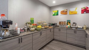 A modern kitchen with a coffee machine, fruit bowls, a microwave, and a coffee pot. - Quality Inn Lebanon - Nashville Area (Lebanon)