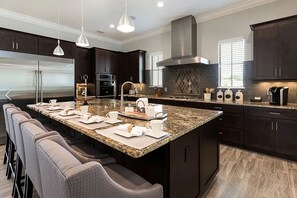 Enjoy cooking in this well-equipped kitchen with a large island and comfortable seating area.