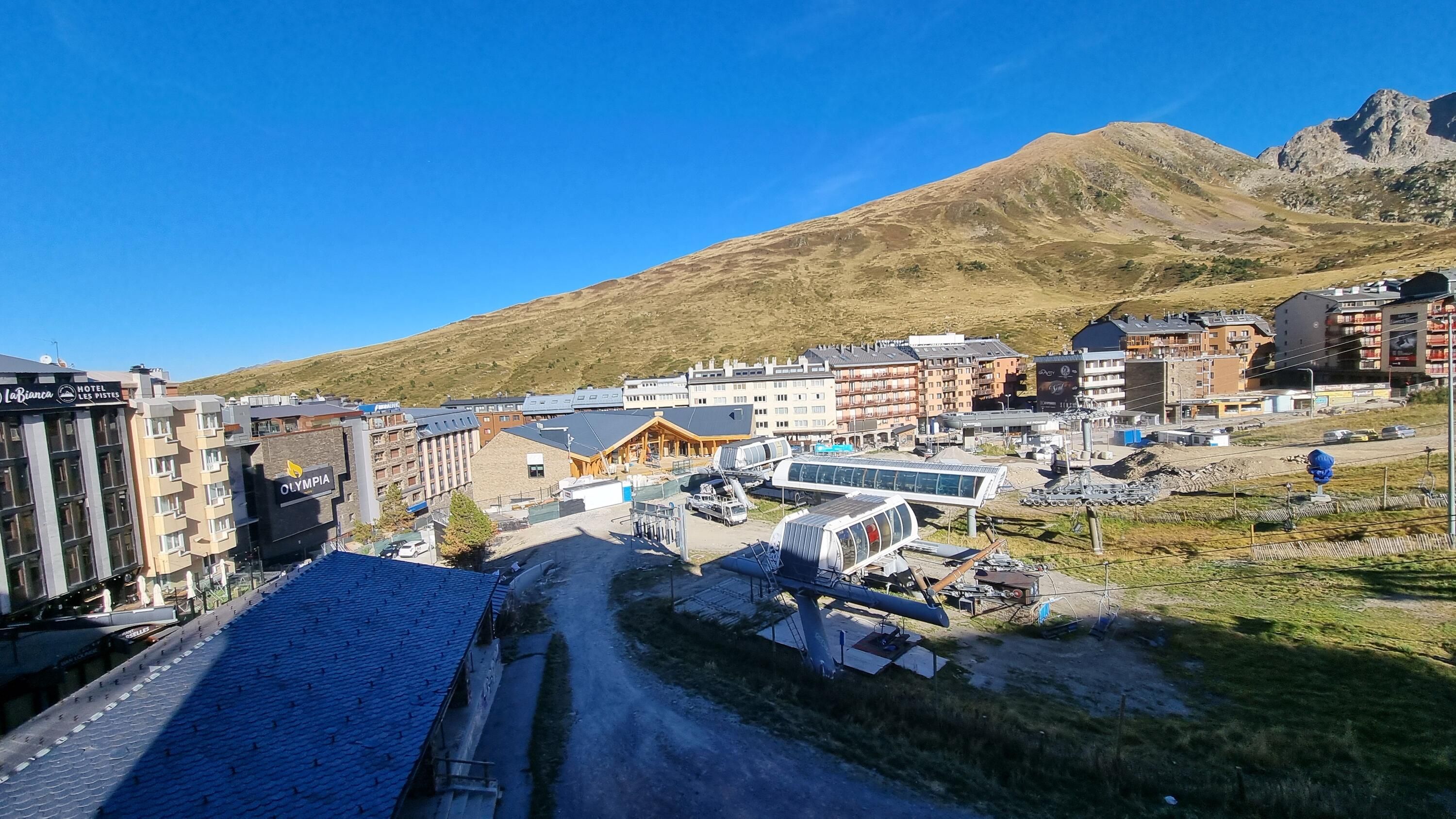 A town with a mix of modern and traditional buildings, including a hotel and a restaurant.