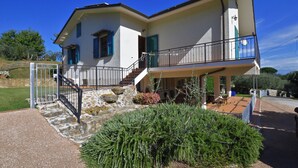 A two-story house with a balcony, stone steps, and a garden. - Casa Andreini, Capannori, Italy (Capannori)