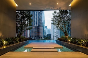 A modern indoor pool with a clear view of surrounding high-rise buildings.