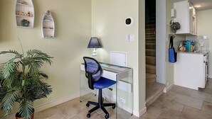 A home office with a desk, chair, and shelves. - Coastal Calm | Split level condo with ocean views (Port Aransas)