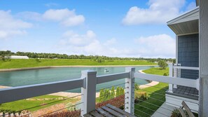 A balcony with a view of a river, a boat, and a green landscape. - 360 Degree Rooftop Views - Perfect for Eagle Watching (Ottawa)
