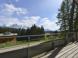 A balcony with a view of snow-capped mountains, a wooden deck, and a metal railing. - 3-room apartment for 6 people in Chamrousse (Chamrousse)