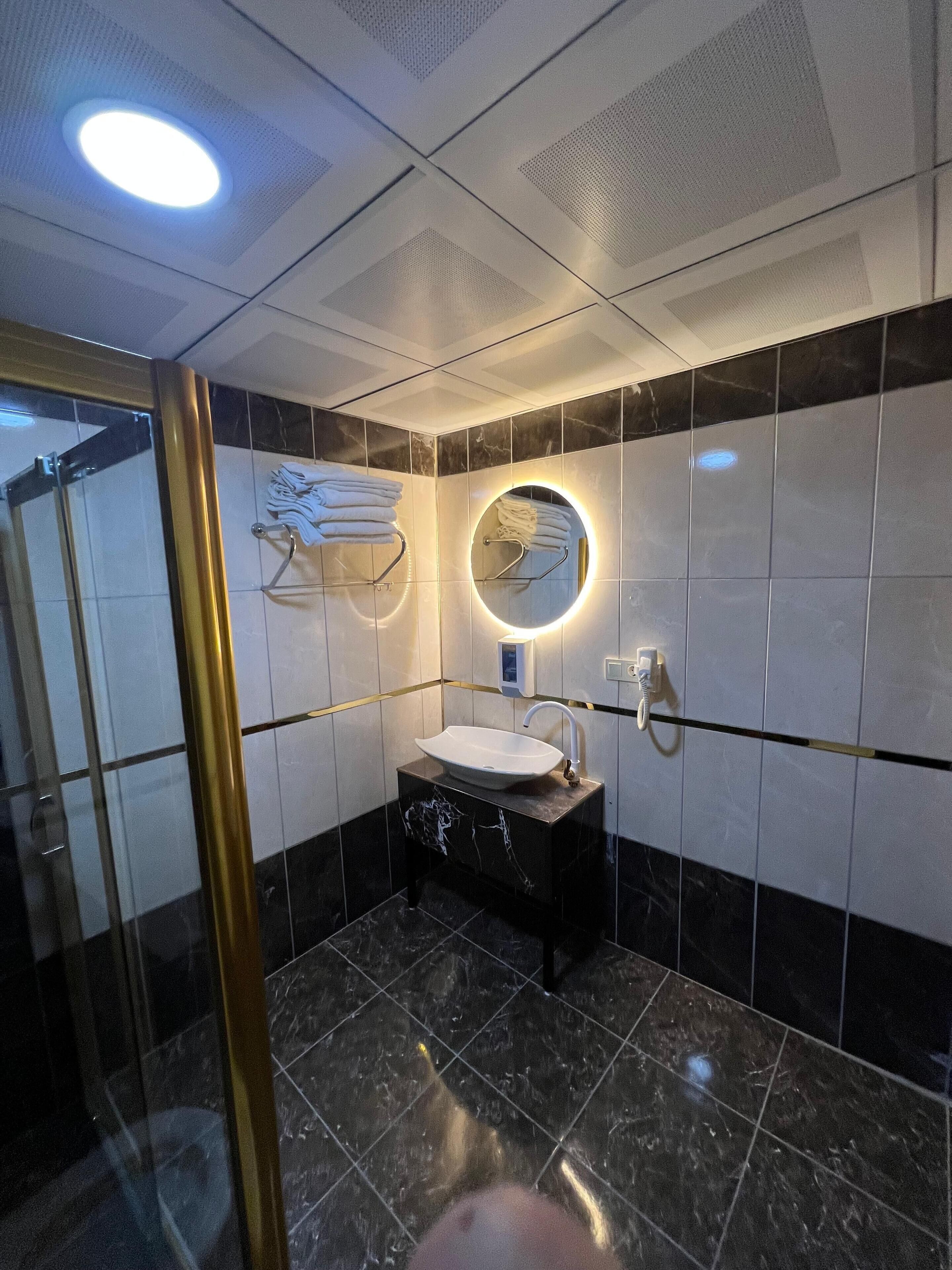 deluxe quadruple room | bathroom | shower, free toiletries, hair dryer, slippers