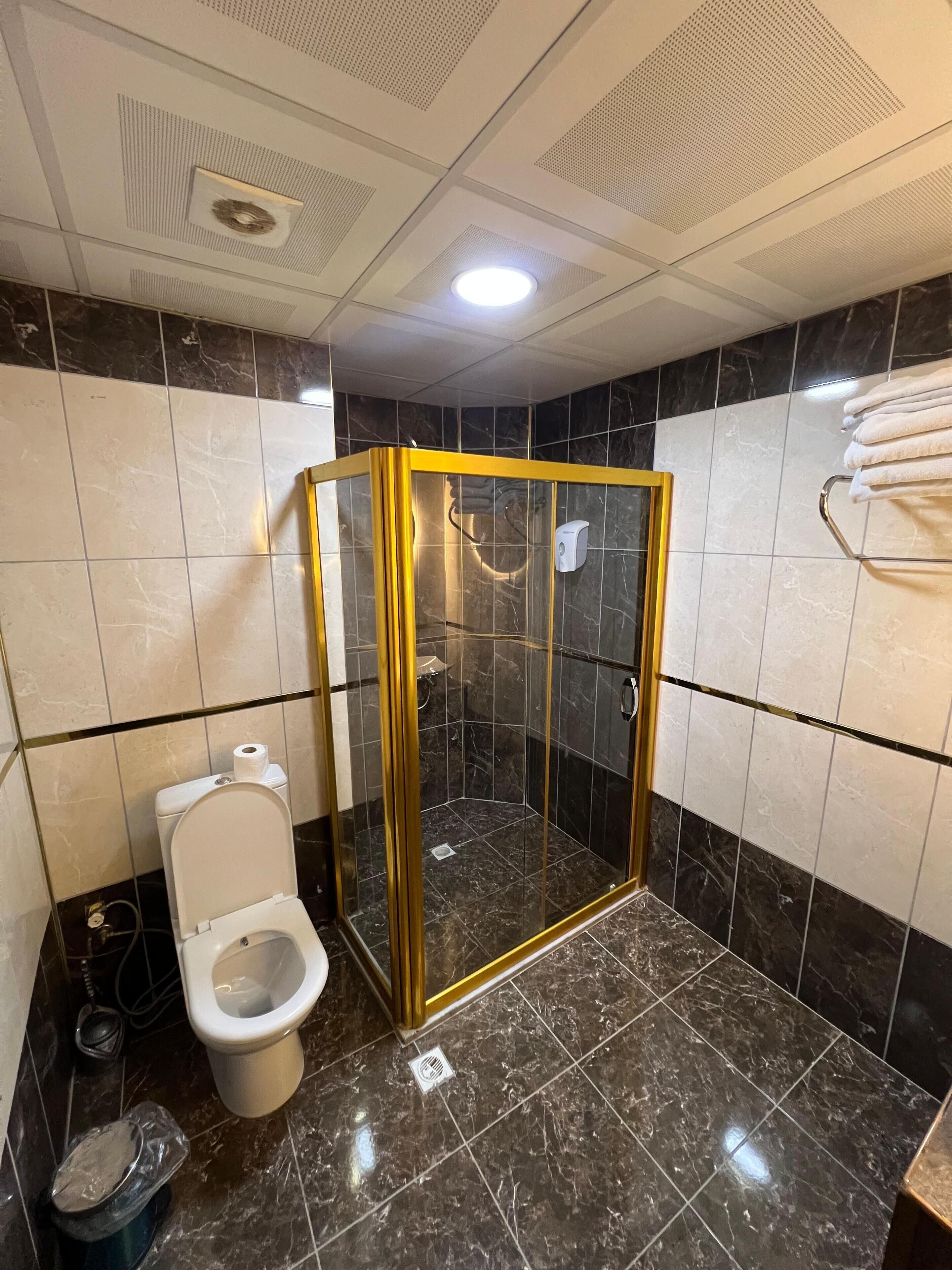 deluxe quadruple room | bathroom | shower, free toiletries, hair dryer, slippers