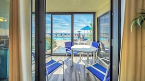 A balcony with a view of a pool area, including lounge chairs and umbrellas. - 2 Bedroom Deluxe Gulf Front, Steps to Beach and Pool! Sleeps 7,  First Floor Con (Panama City)