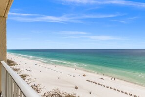 A beach with clear skies, a sandy shore, and a few people. - 3-bedroom Gulf Front Condo on world’s most beautiful beach (Panama City Beach)