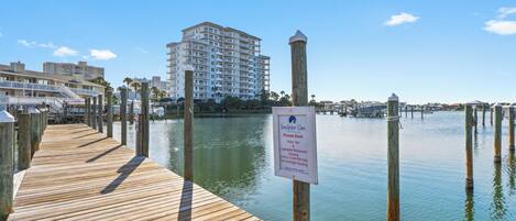 A wooden pier leading to a private dock with a sign indicating it is a water taxi and private dock area.