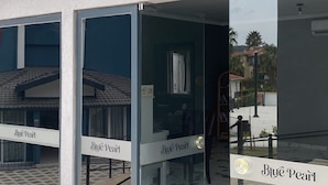 A reception area with a sign labeled "RECEPTION" above a glass door. - BLUE PEARL HOTEL& VILLAS (Fethiye)
