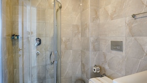 A modern bathroom with a glass-enclosed shower, a toilet, and a sink. - BLUE PEARL HOTEL& VILLAS (Fethiye)