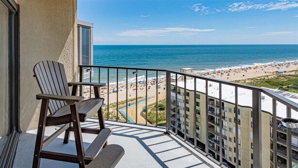 A balcony with a view of a beach and ocean. - 9400 Building - Oceanfront Condo with Panoramic views of the ocean and bay! (Ocean City)