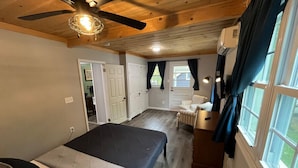 A bedroom with a bed, a desk, a chair, and a window. - Wally`s House   |Kayaks|Firepit|Game Shed|Central! (Hawley)