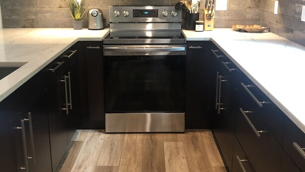 A modern kitchen with stainless steel appliances, wooden cabinets, and a tiled backsplash. -   Come enjoy this mountain retreat this Fall! (Saluda)