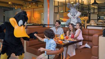 A family dining in a restaurant with a mascot.