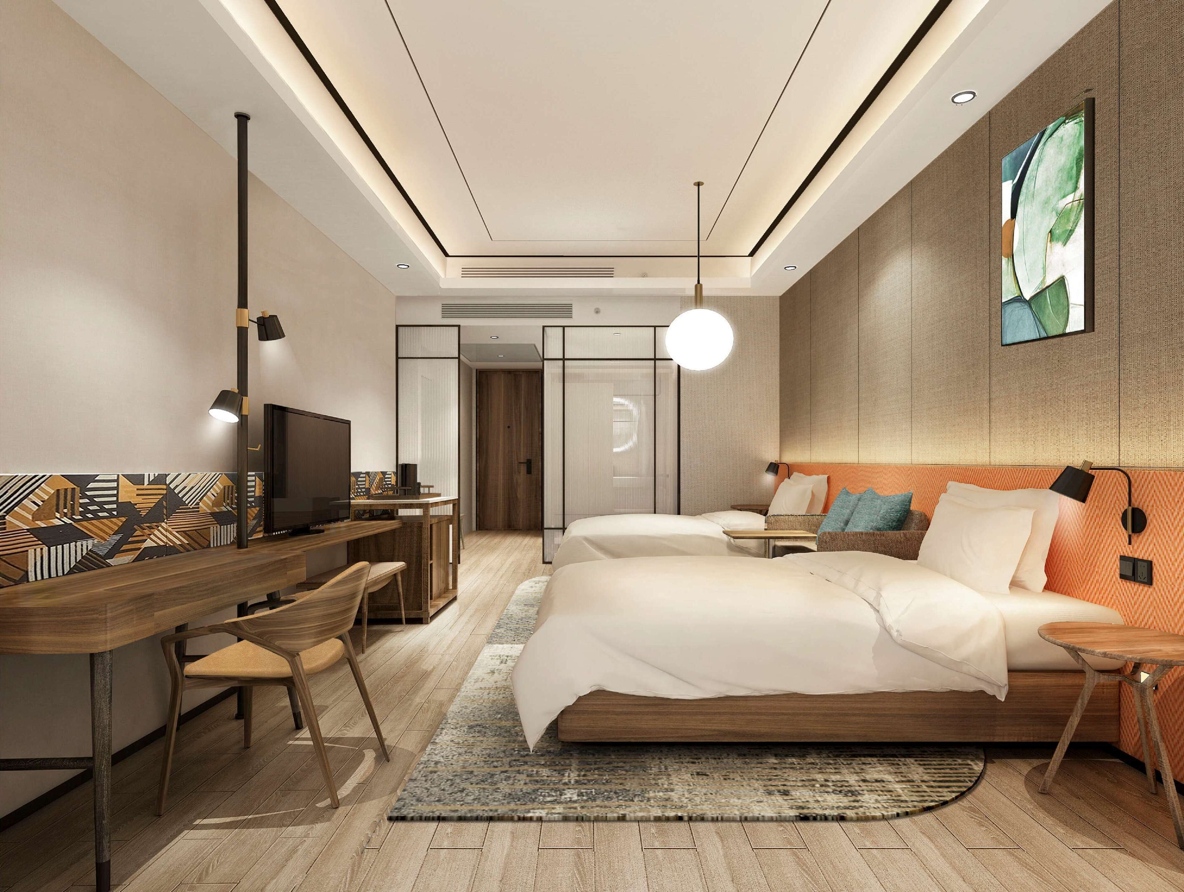 A modern hotel room with a wooden desk, two beds, and a large abstract painting on the wall.