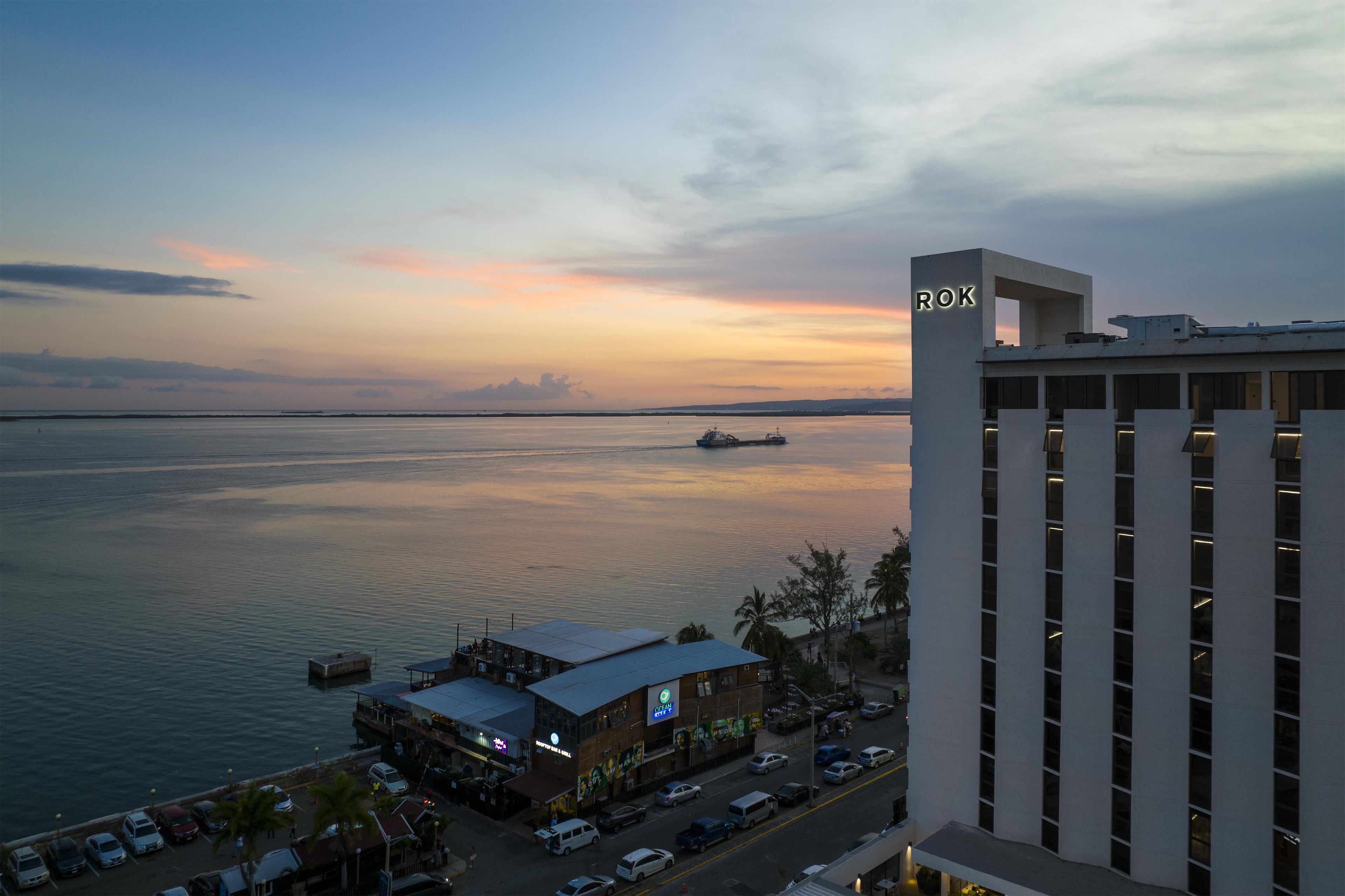 A waterfront view with a building labeled 'ROK' and a restaurant with outdoor seating.