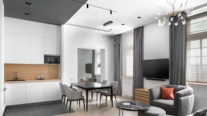 A modern living space with a kitchen, dining area, and seating area. - The Basilian Minsk, Curio Collection By Hilton (Minsk)