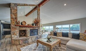 Cozy seating area with a fireplace, large mirror, and comfortable sofa.