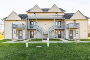 A two-story building with a symmetrical facade, featuring balconies on each floor. - ⛰️☀️ SKIING, HIKING, VILLAGE OF ELLICOTTVILLE MOUNTAIN ESCAPE (Ellicottville)