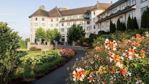 A large, multi-story hotel with a central courtyard and a landscaped garden. - Twin Creeks Refuge, a log cabin, Pet friendly (Maggie Valley)