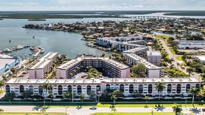 A hotel with a central courtyard, multiple floors, and a marina with boats.