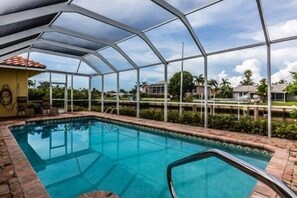 Relax by the pool with a view of the surrounding landscape.
