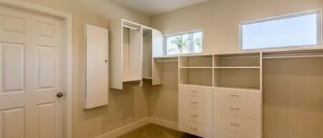 A room with a closet, a door, and a window.