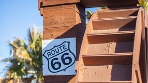 A wooden structure with a sign indicating Route 66. - Route 66 Motel (Barstow)