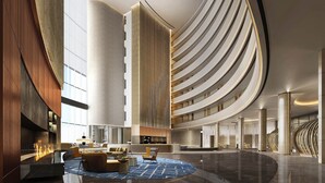 A spacious lobby with a central seating area, a high ceiling, and a modern architectural design. - Sheraton Rizhao Hotel (Rizhao)
