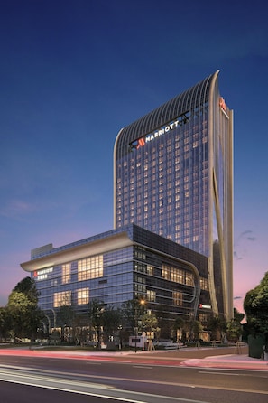 A modern hotel with a curved facade, large windows, and a prominent 'Marriott' sign. - Wenzhou Marriott Hotel (Wenzhou)
