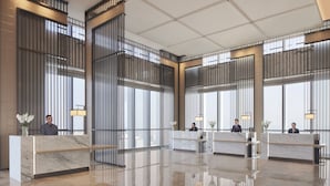 A modern hotel lobby with marble reception desks, large windows, and a polished floor. - Jinhua Marriott Hotel (Jinhua)