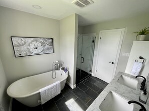 Bathtub, towels, soap, toilet paper