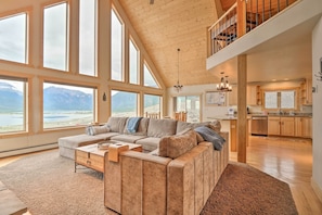 Relax in this inviting living area with a panoramic view of the surrounding landscape through expansive windows.