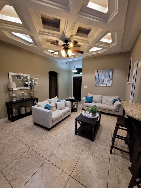 A spacious living room with two sofas, a coffee table, and a ceiling fan. - Isabella's getaway (Edinburg)