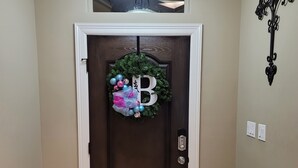 A dark brown door with a decorative wreath and a large letter B. - Isabella's getaway (Edinburg)