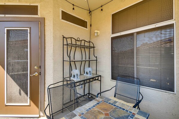 Relax in this serene outdoor seating area with a table and chairs, a bench, and decorative accents.