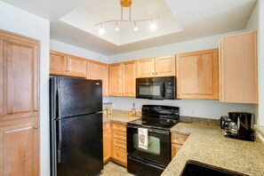 Enjoy cooking in this well-equipped kitchen with a refrigerator, microwave, oven, and coffee maker.